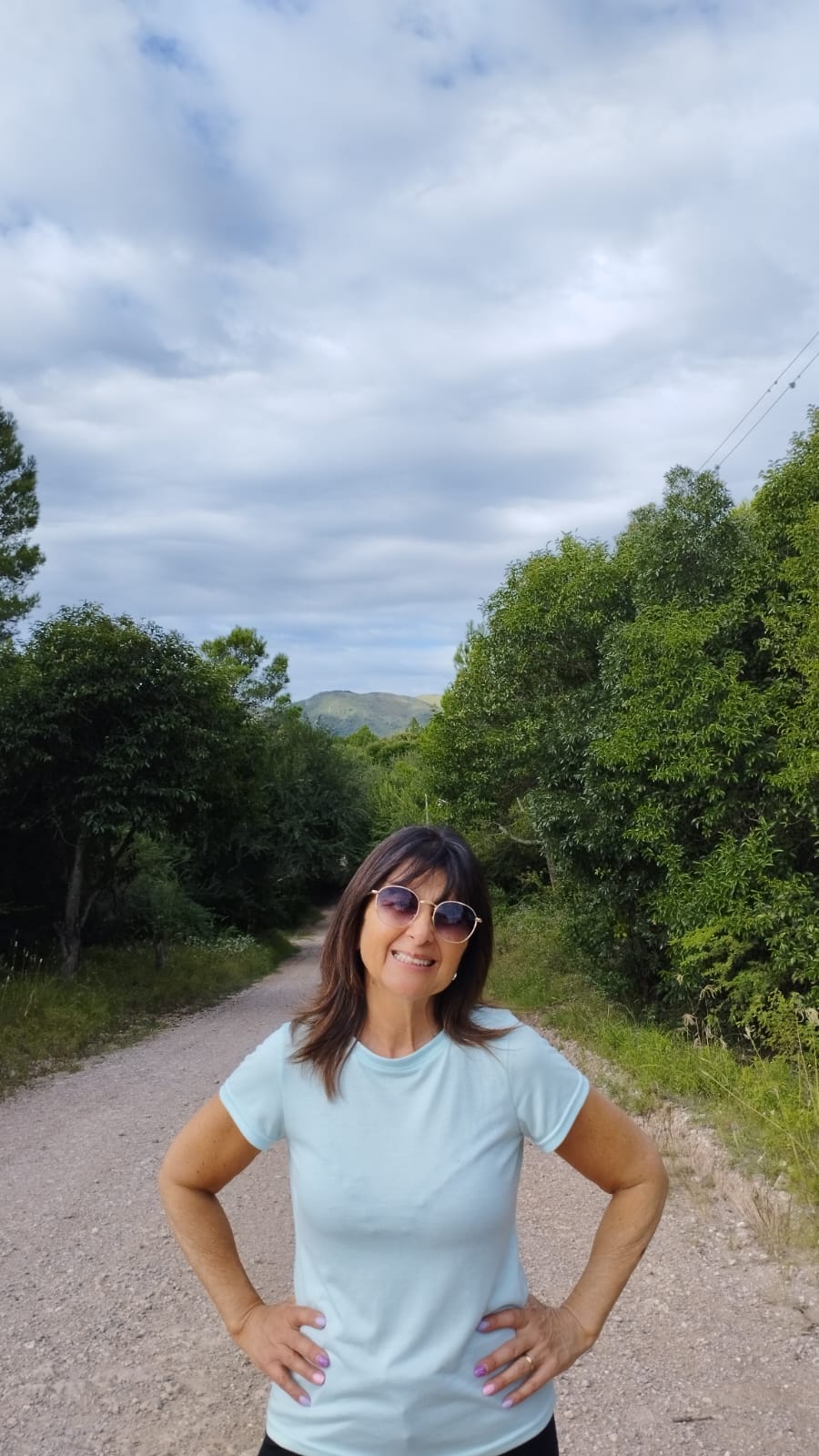 Olga Ledezma de pie en un camino rodeado de naturaleza